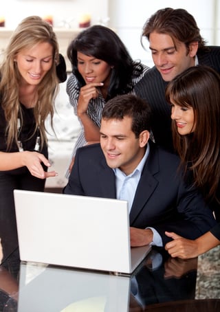 Business group at an office working on a laptop.jpeg