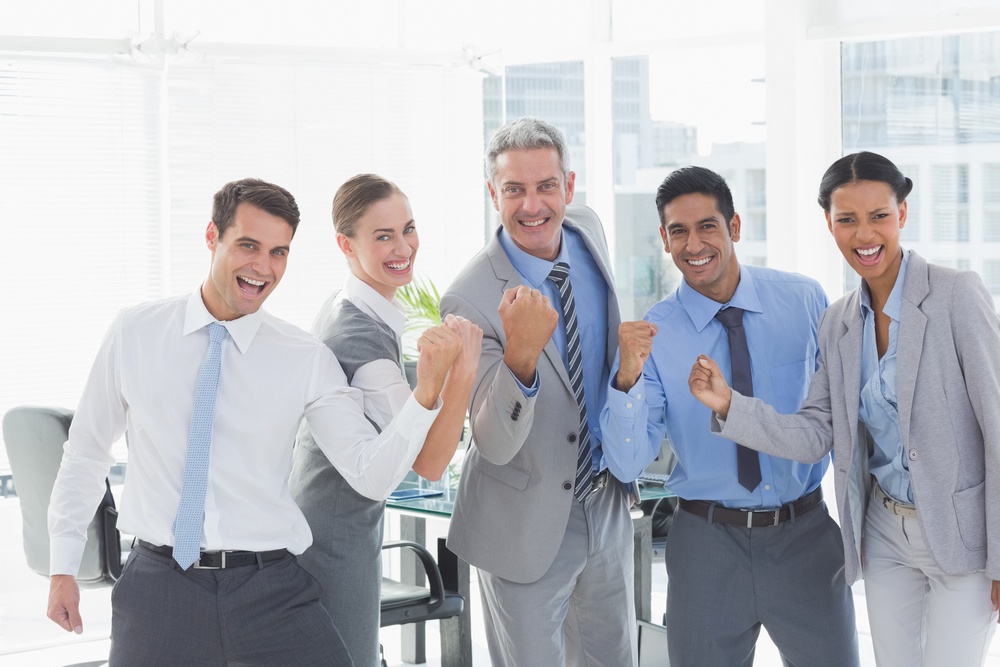 Portrait of cheerful business people cheering in the office.jpeg